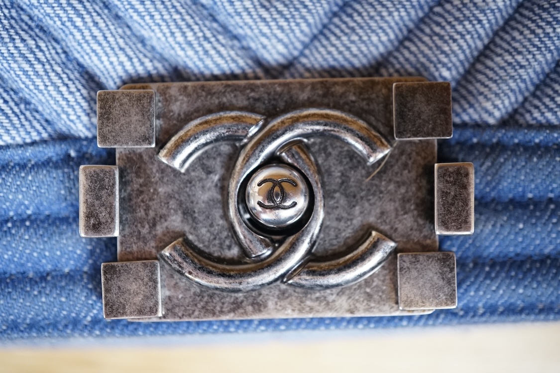 A Chanel denim cheveron flap shoulder bag with silver hardware, date code 20845697, 28cm wide